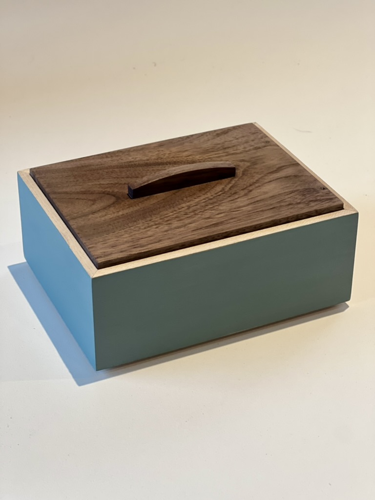 Handmade storage box with painted blue-grey sides and solid walnut lid with sculpted handle
