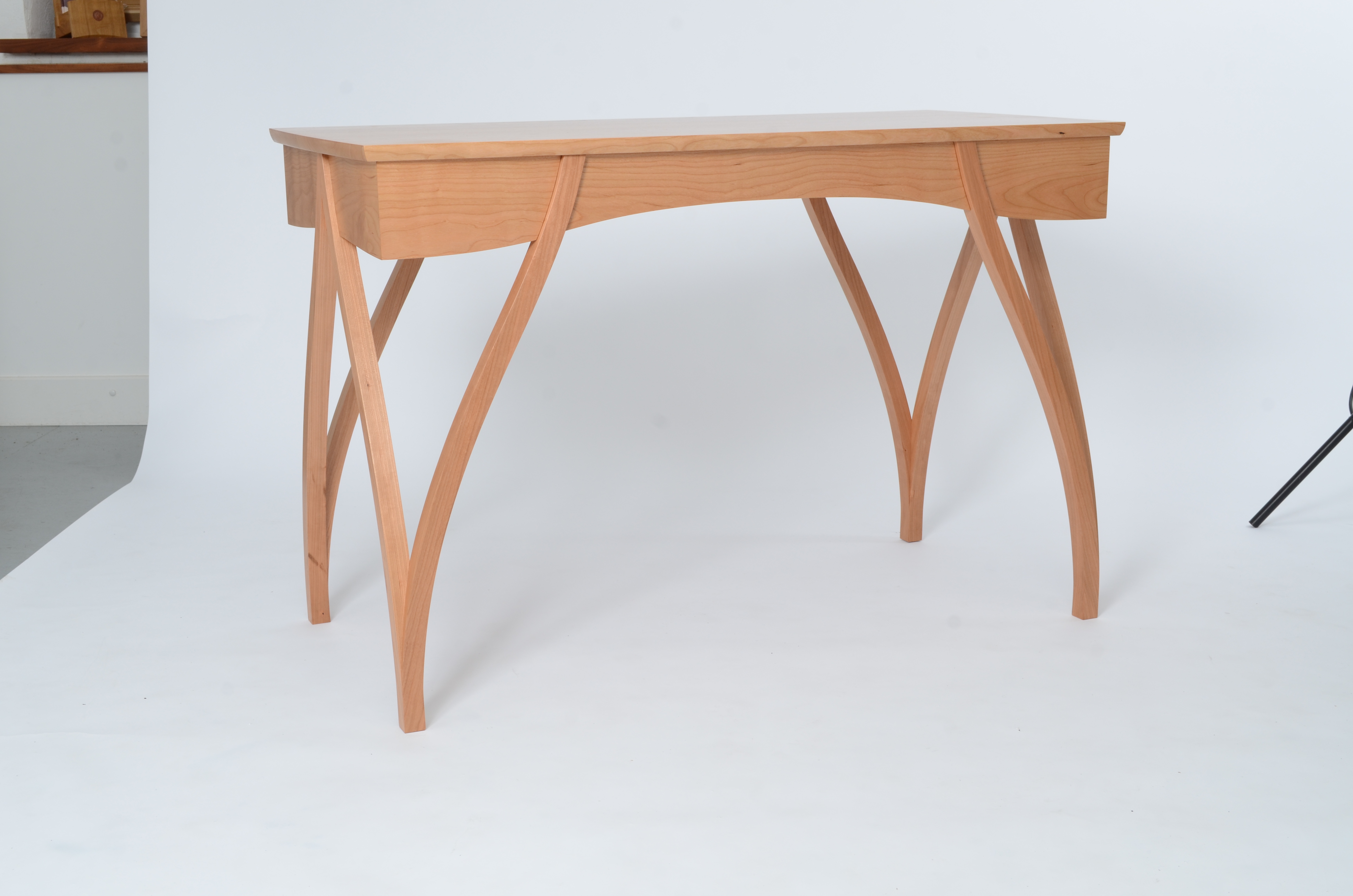 Bespoke cherry writing desk with distinctive crossed arched legs and two drawers, handmade in the Lake District