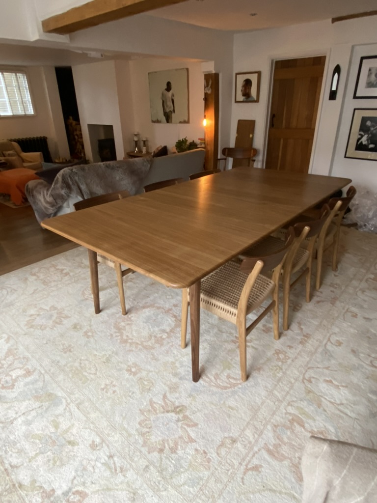 Large bespoke oak dining table installed in a family home, seats eight, handcrafted by Mark Eden Design