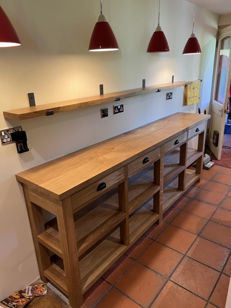 Bespoke oak kitchen dresser and prep counter with drawers and open shelves, installed in a farmhouse kitchen