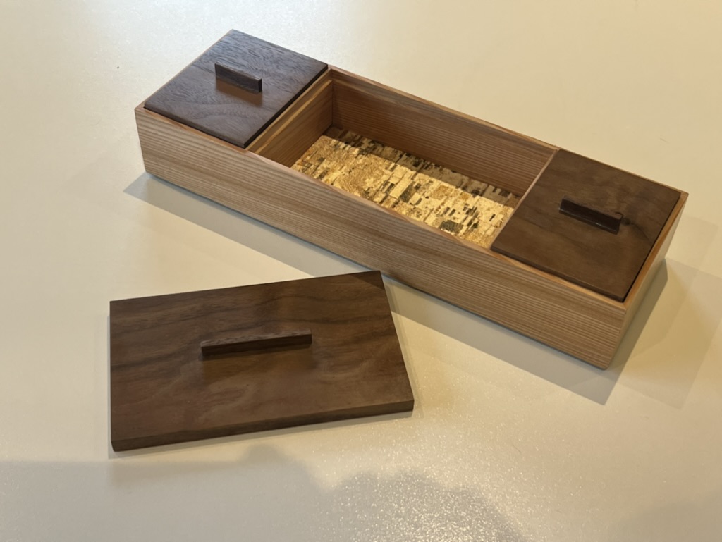 Bespoke ash keepsake box with walnut lid panels and compartmented interior, handmade by Mark Eden Design